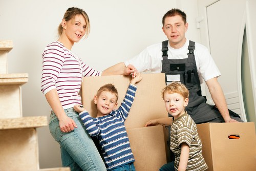 Furniture pick-up team handling bulky items in Kensal Green street setting
