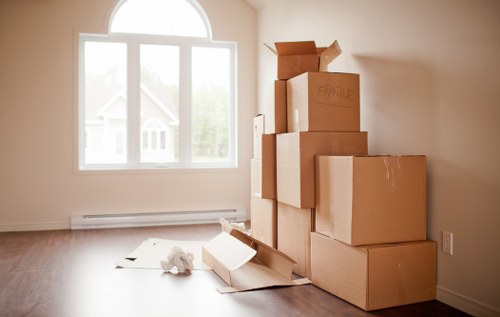 Moving crew handling office equipment and furniture at a Kensal Green property