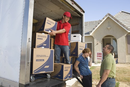 Careful loading of boxes and furniture into a local moving van