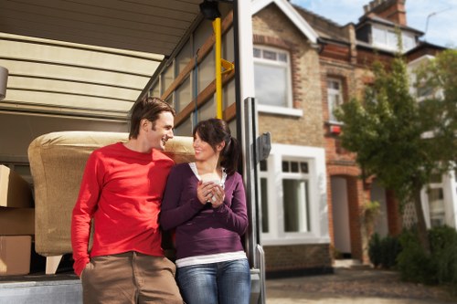 Professional movers carrying boxes in a Kensal Green street